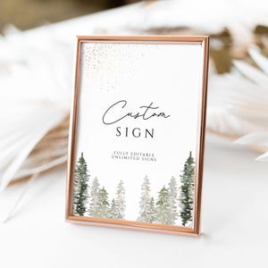 May include: A printable sign with a gold frame and a white background. The sign says "Custom Sign" in black text and "Fully Editable Unlimited Signs" in smaller black text. The sign has a watercolour design of green trees with white accents.