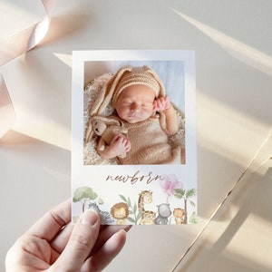 May include: A newborn baby announcement card with a photo of a baby sleeping in a brown knitted outfit. The card features a jungle theme with illustrations of animals like a zebra, lion, giraffe, and a hippo. The text "newborn" is written in brown cursive.
