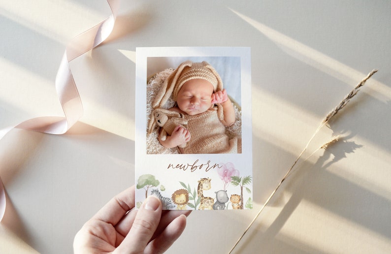 May include: A newborn baby announcement card with a photo of a baby sleeping in a brown knitted outfit. The card features a jungle theme with illustrations of animals like a zebra, lion, giraffe, and a hippo. The text "newborn" is written in brown cursive.