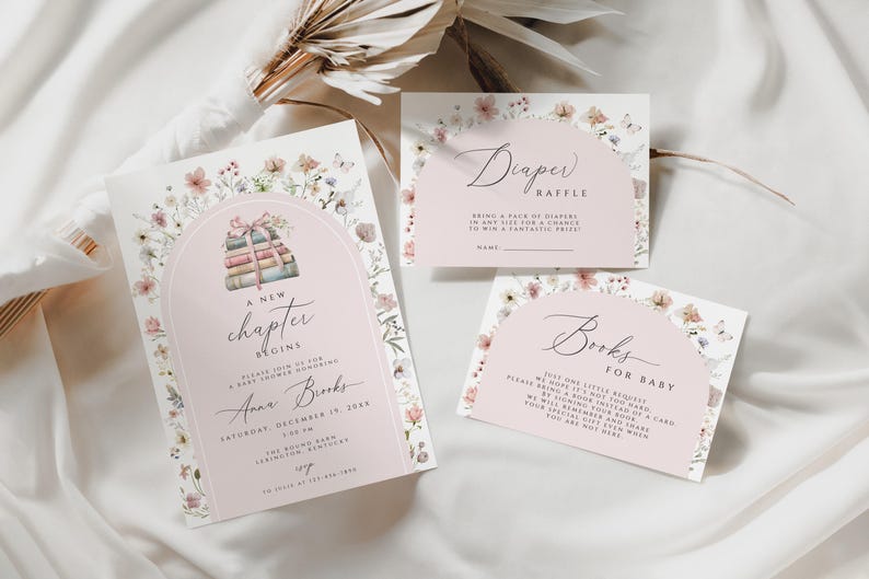 May include: A pink and white baby shower invitation with floral illustrations. The invitation reads "A new chapter begins" and includes the name "Anna Brooks". There are also two cards for a diaper raffle and a book request for the baby.