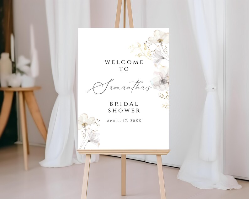 Puede incluir: Se&ntilde;al de bienvenida para una despedida de soltera con flores blancas y el texto "Bienvenida a la despedida de soltera de Samantha, 17 de abril de 20XX".