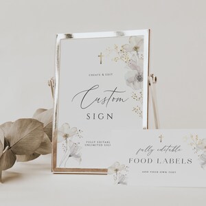 May include: A set of printable wedding signs with a watercolor floral design. The sign on the left says "Custom Sign" and the sign on the right says "Fully Editable Food Labels".