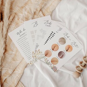 May include: Four printable baby shower game cards with floral designs. The games are "Who Knows Mommy?", "Baby Cross", "Guess the Baby Butt", and "Baby Bingo".