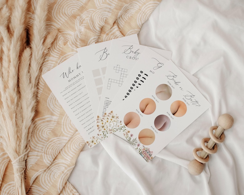 May include: Four printable baby shower game cards with floral designs. The games are "Who Knows Mommy?", "Baby Cross", "Guess the Baby Butt", and "Baby Bingo".