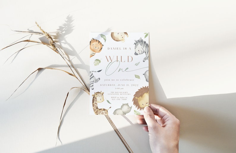 May include: A white invitation card with a watercolor illustration of jungle animals. The text reads "Daniel is a Wild One" and "Join us to celebrate Saturday, June 11, 2022".