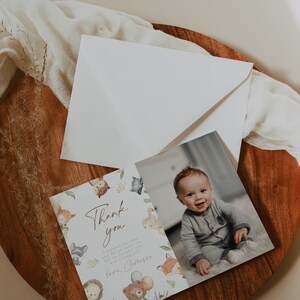 May include: Thank you card with a cute woodland animal theme. The card features a photo of a baby in a blue outfit and the text "Thank you. I enjoyed the cake and the presents too, but the best part was meeting you. Love, [Name]"