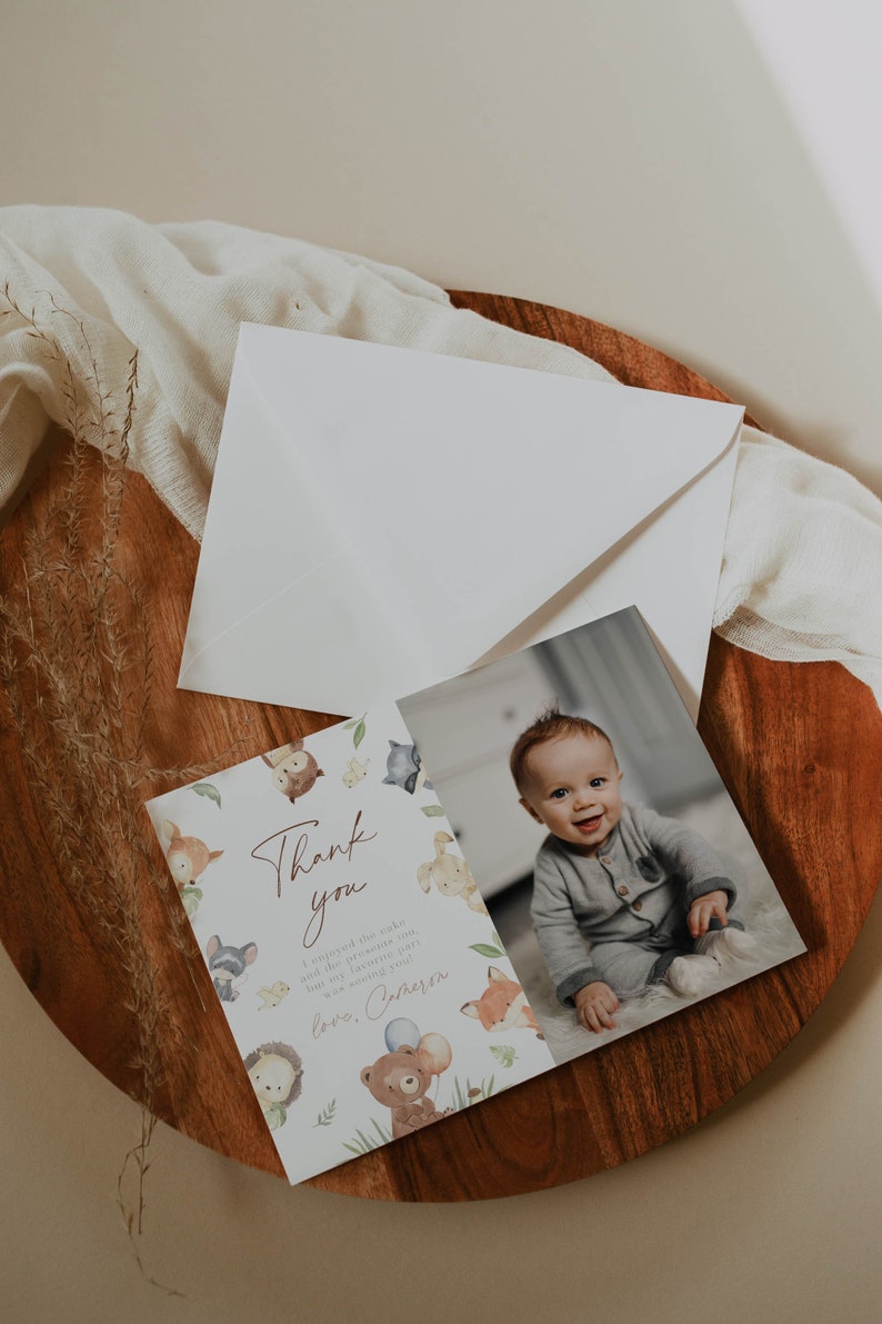 May include: Thank you card with a cute woodland animal theme. The card features a photo of a baby in a blue outfit and the text "Thank you. I enjoyed the cake and the presents too, but the best part was meeting you. Love, [Name]"
