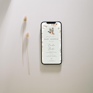 May include: A digital invitation for a baby shower with a watercolor illustration of a duck flying in a green archway with floral accents. The text reads "Please join us for a Baby Shower honoring Emily Banks".