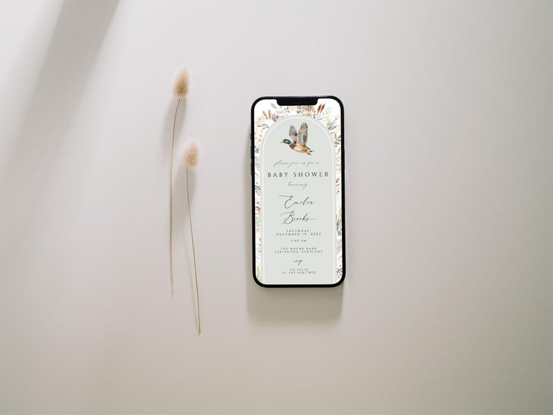 May include: A digital invitation for a baby shower with a watercolor illustration of a duck flying in a green archway with floral accents. The text reads "Please join us for a Baby Shower honoring Emily Banks".