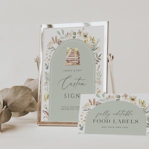 May include: A printable sign with a green background and floral border. The sign says "Create & Edit Custom Sign" and "Fully Editable, Unlimited Size". A smaller sign with a similar design says "Fully Editable Food Labels, Add Your Own Text".