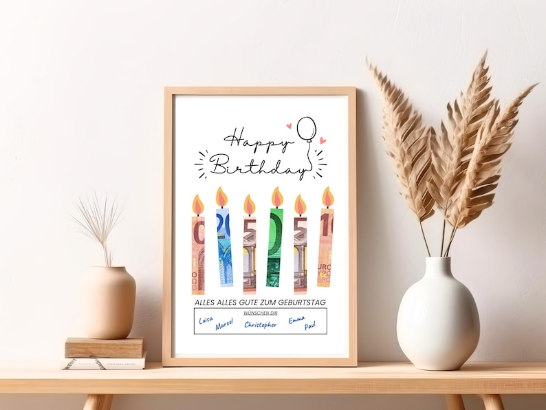 May include: A white framed print with the text "Happy Birthday" and a balloon. Five candles made of euro bills are arranged in a row with the numbers 1, 5, 5, 2, and 1. The text "Alles Alles Gute Zum Geburtstag" is below the candles. The names "Louisa, Marcel, Christopher, Emma, Paul" are written below the text.