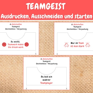 May include: Three printable team building activity cards with the text "du Botschaften Teamgeist Geschenkbox/Verpackung" at the top of each card. The first card has the text "Du wei&szlig;t. Teamwork makes the dream work" and two smiley faces. The second card has the text "Nur im Team ist man stark" and two hands clapping. The third card has the text "Du bist ein wahrer Teamplayer".