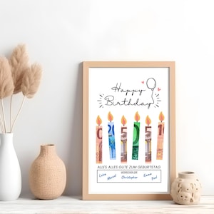 May include: A white framed print with the text "Happy Birthday" and a drawing of candles made from money. The candles are labeled with the numbers 1, 5, and 2. The text "Alles Alles Gute Zum Geburtstag" is below the candles. The names "Luis, Marcel, Christopher, Emma, Paul" are listed below the text.