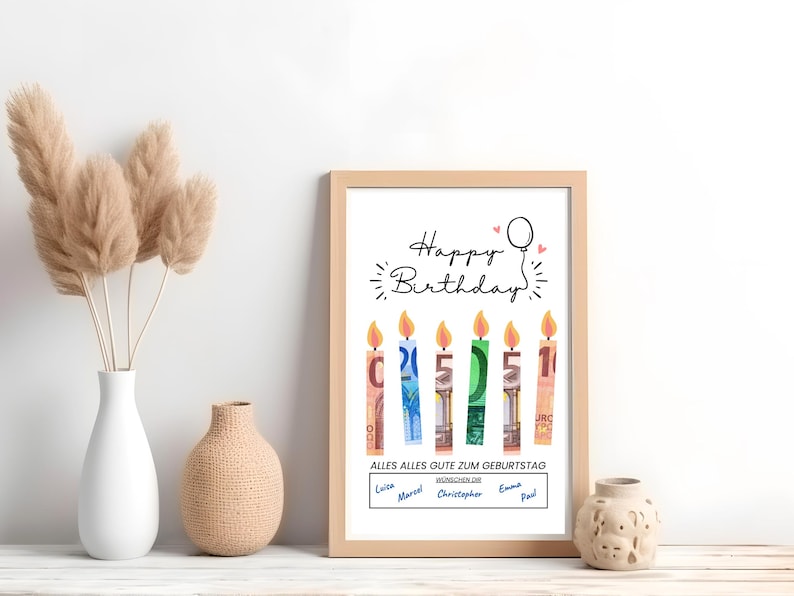 May include: A white framed print with the text "Happy Birthday" and a drawing of candles made from money. The candles are labeled with the numbers 1, 5, and 2. The text "Alles Alles Gute Zum Geburtstag" is below the candles. The names "Luis, Marcel, Christopher, Emma, Paul" are listed below the text.