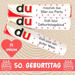 May include: Three white chocolate bars with red hearts and the text "du" in black. The bars have different messages: "machst die 50er zur Party", "bist das Geburtstagskind", and "bist wie ein guter Wein". A red heart with the text "71 Spr&uuml;che" is below the bars. A red banner with the text "50. GEBURTSTAG" and a white cake with candles is below the heart.