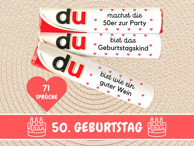 May include: Three white chocolate bars with red hearts and the text "du" in black. The bars have different messages: "machst die 50er zur Party", "bist das Geburtstagskind", and "bist wie ein guter Wein". A red heart with the text "71 Spr&uuml;che" is below the bars. A red banner with the text "50. GEBURTSTAG" and a white cake with candles is below the heart.