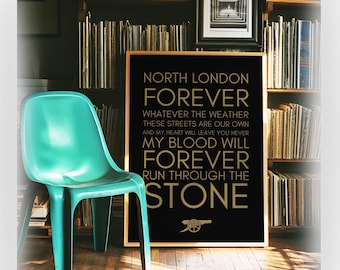 May include: A rectangular framed poster with a black background and gold text that reads: NORTH LONDON FOREVER WHATEVER THE WEATHER THESE STREETS ARE OUR OWN AND MY HEART WILL LEAVE YOU NEVER MY BLOOD WILL FOREVER RUN THROUGH THE STONE with a cannon icon.