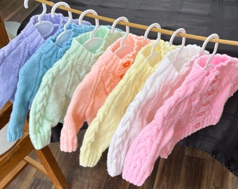 Baby cardigans, hand knitted in seven colours. Cardigan chest measures 46cm (approx 3 - 6 months