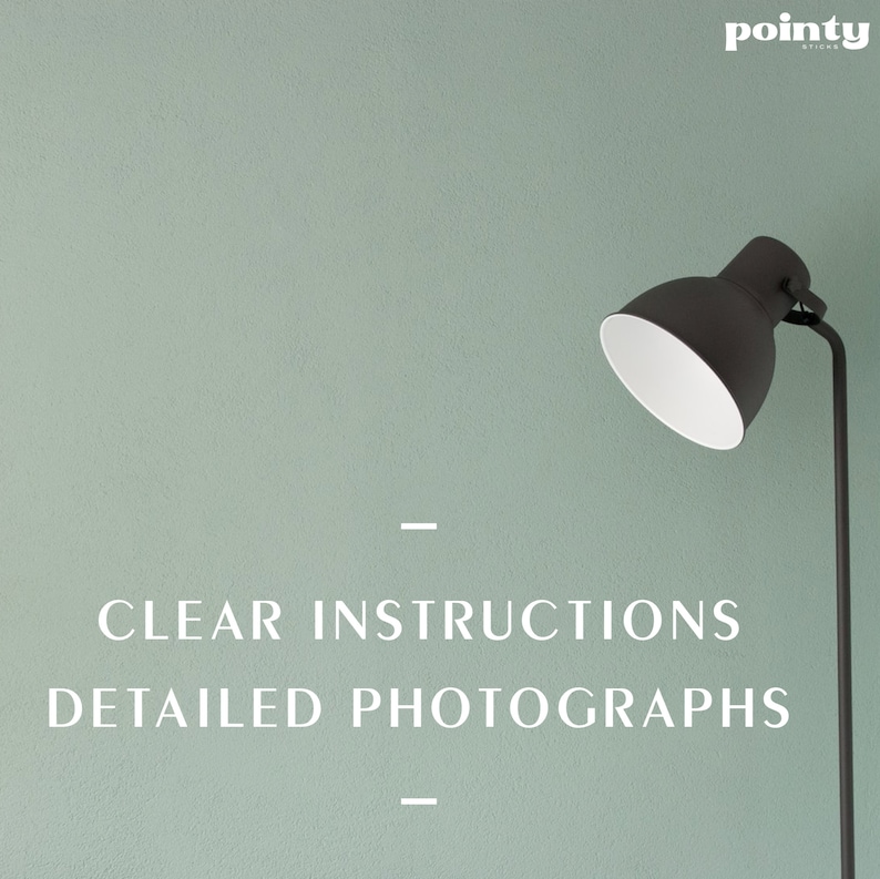May include: A black lamp with a white shade against a light green wall. The text "CLEAR INSTRUCTIONS DETAILED PHOTOGRAPHS" is printed below the lamp.