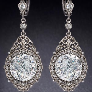 May include: A pair of ornate silver earrings with large, faceted, clear gemstones. The earrings feature a detailed filigree design around the central stones and smaller accent gems. The design is symmetrical and elegant, suitable for formal occasions.