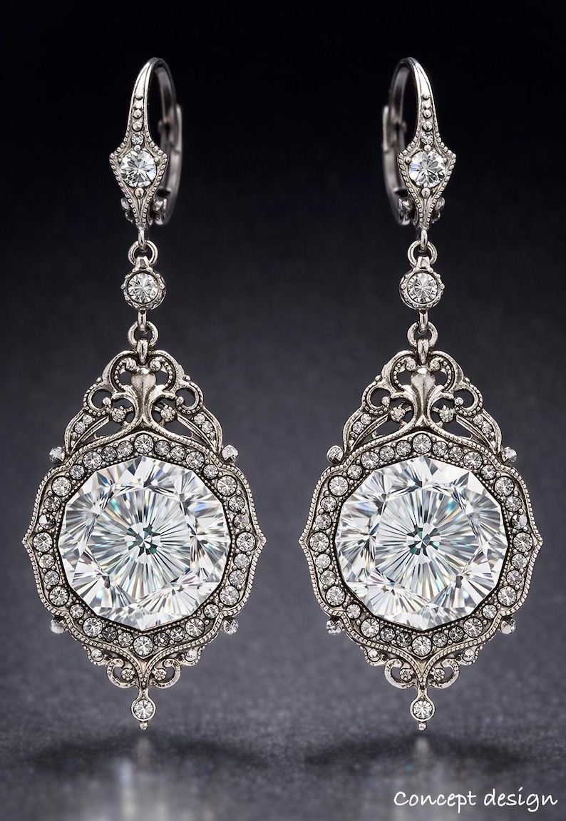 May include: A pair of ornate silver earrings with large, faceted, clear gemstones. The earrings feature a detailed filigree design around the central stones and smaller accent gems. The design is symmetrical and elegant, suitable for formal occasions.