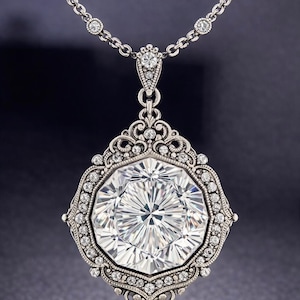 May include: A silver pendant necklace featuring a large, faceted, clear gemstone. The gemstone is surrounded by a decorative frame with smaller, clear gemstones. The necklace chain also has small, clear gemstones. The words "Concept design" are at the bottom.