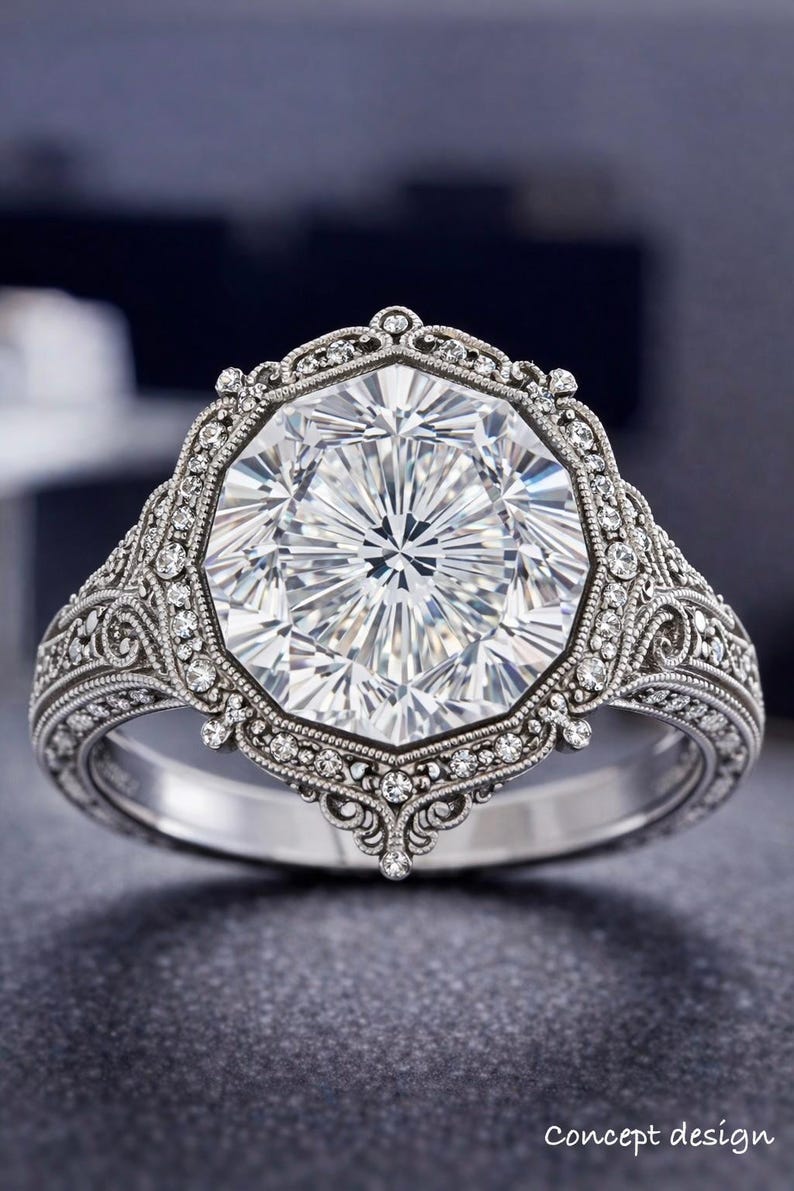 May include: A detailed, silver-toned ring with a large, faceted, clear gemstone at its center. The ring features intricate filigree and small accent stones around the main stone and along the band. The words "Concept design" are at the bottom.