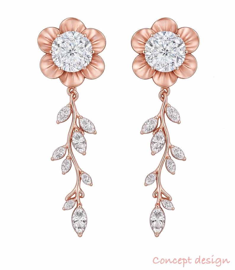 May include: A pair of rose gold earrings. Each earring features a flower-shaped top with a large, round, clear stone center. Below, a delicate vine with marquise-cut stones and leaf details hangs gracefully. The text "Concept design" is at the bottom.