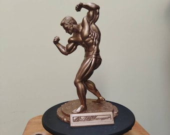 Arnold Schwarzenegger posing statue on platform with signature - Dark Gold