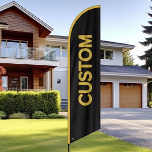 May include: A black custom feather flag with gold trim and the word "CUSTOM" in gold lettering. The flag is displayed outdoors in front of a house with a green lawn.