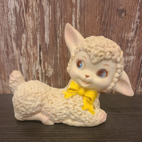 Cute lamb squeaky toy.  Lamb with a yellow bow.