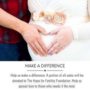 May include: A couple's hands form a heart shape over a pregnant belly. The woman is wearing a white dress with a floral sash. The man is wearing a red and black plaid shirt. The text "MAKE A DIFFERENCE" is at the bottom of the image.
