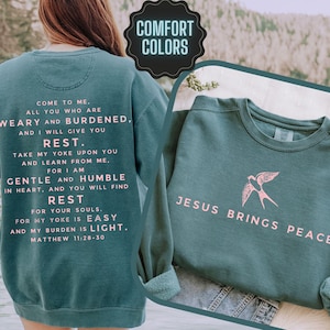 This Comfort Colors sweatshirt says Jesus Brings Peace on the front with a bird graphic and on the back is the Bible verse Matthew 11: 28-30. This is a great woman Christian gift for her.  The scripture is in a minimalist font.