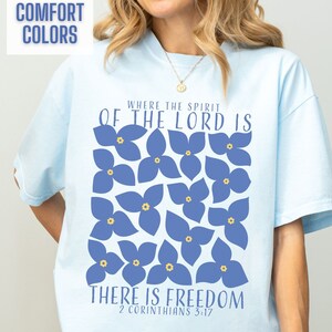 This boho Christian graphic tee for women comes in bright and colorful Comfort Colors brand shirts. The blue flower design is so cute with a Bible verse to go along with it.  This makes a wonderful Christian Women gift or an adult baptism gift.