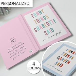 May include: A pink and blue personalized book with the text "FUNNY THINGS CHARLOTTE SAID...so I'll never forget" and "FUNNY THINGS CARVER SAID...so I'll never forget". The book is open to show the inside pages. The book is a personalized gift for a child.