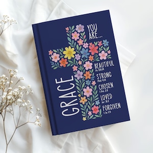 Personalized Christian journal for women and girls with a floral cross design on the cover. The front features “You Are” affirmations with Bible verses and a custom name option. Available in 8 colors, this faith-based notebook can be used for prayer journaling, Bible study notes, gratitude, reflections, and daily writing. Optional customization available for spine and back cover text. Feminine, inspirational gift idea for teens, women, church, or special occasions.