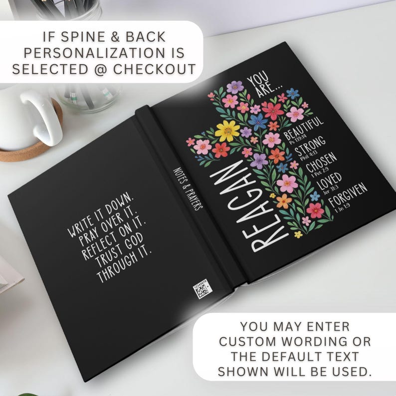 May include: Black journal with the name "Reagan" in white, a floral cross design, and inspirational text. The journal's cover features the words "You are... Beautiful, Strong, Chosen, Loved, Forgiven." The inside cover has the text "Write it down. Pray over it. Reflect on it. Trust God through it."