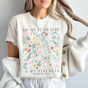 The popular Comfort Colors ivory colored t shirt is so beautiful as a background for this elegant flower graphic. This would make an awesome gift for religious ladies who have faith in Jesus Christ.
