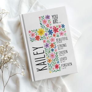Personalized Christian journal for women and girls with a floral cross design on the cover. The front features “You Are” affirmations with Bible verses and a custom name option. Available in 8 colors, this faith-based notebook can be used for prayer journaling, Bible study notes, gratitude, reflections, and daily writing. Optional customization available for spine and back cover text. Feminine, inspirational gift idea for teens, women, church, or special occasions.