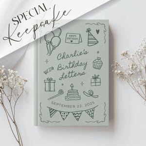 May include: A light green keepsake book with the words "Special Keepsake" in cursive. The book cover features the text "Charlie's Birthday Letters" and doodle illustrations of balloons, a birthday hat, and a cake. The date "September 22, 2025" is also visible.