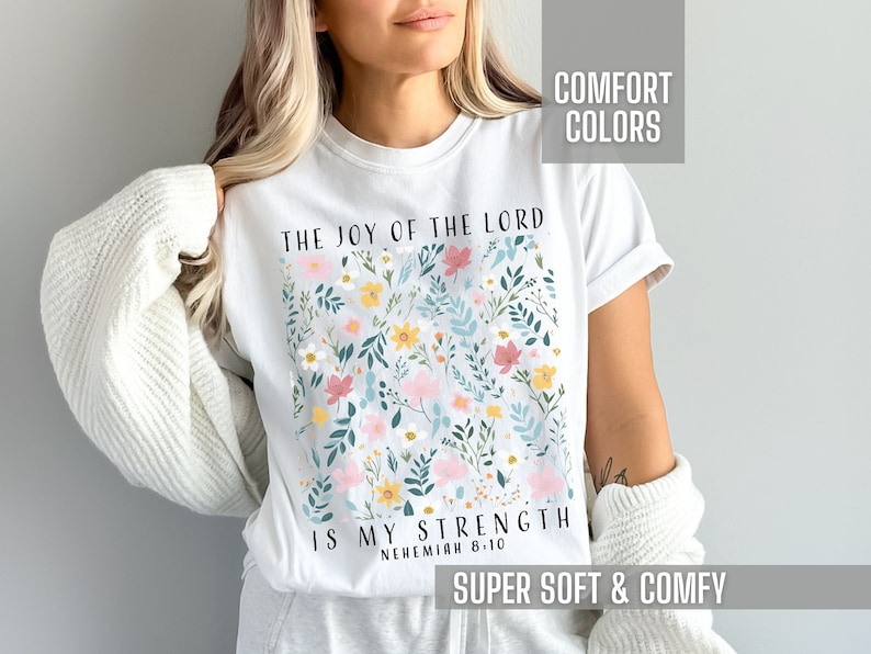 This Christian Shirt for women is so cute for a Christian woman or teen girl.  This floral graphic is so adorable.  It says the Bible verse Nehemiah 8:10. The joy of the Lord is my strength.