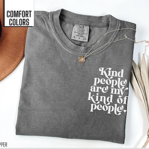 May include: Gray t-shirt with the text "Kind people are my kind of people." printed in white. The shirt is made by Comfort Colors.