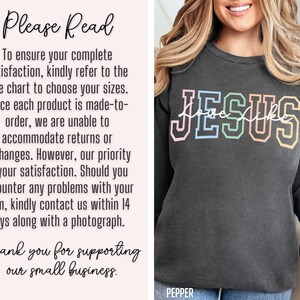 May include: A dark grey sweatshirt with the text "JESUS" in rainbow colours. The text "love like" is written in a smaller font underneath the word "JESUS". The text "PEPPER" is printed on the bottom of the sweatshirt.