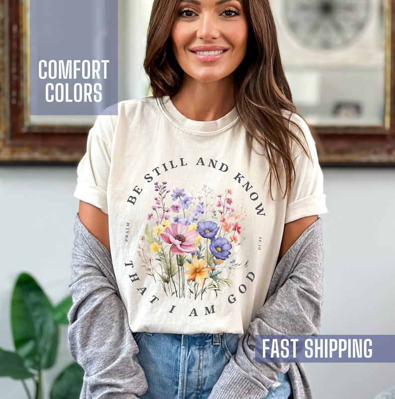 This beautiful floral Christian shirt says, be still and know that I AM God.  It is based on the jkv Bible verse Psalm 46:10.  The vibrant colors are so pretty against these Comfort Colors brand popular tees.
