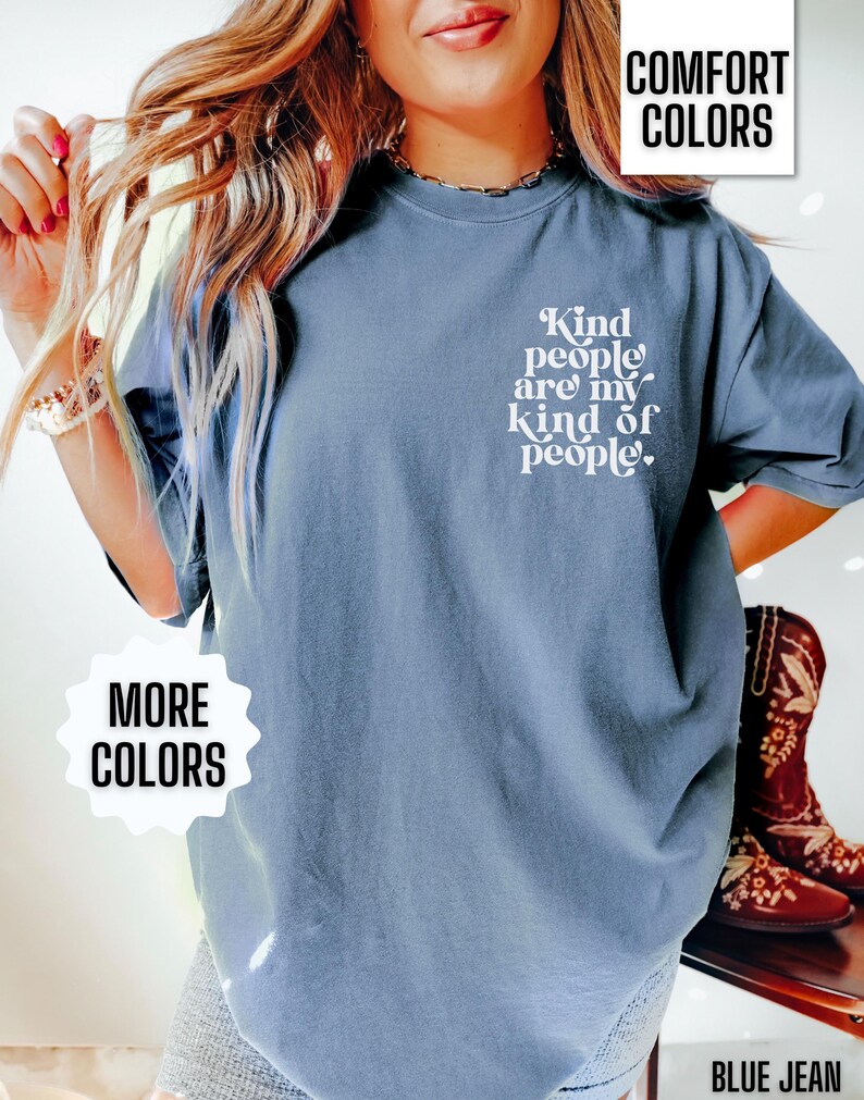 May include: A blue t-shirt with the text "Kind people are my kind of people." printed on the front. The shirt is shown on a model wearing blue jeans.
