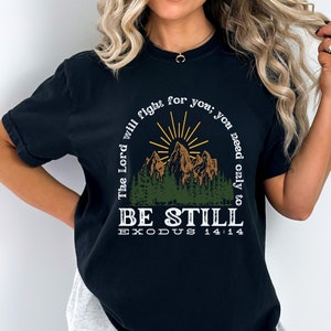 May include: Black t-shirt with a mountain scene and the text "The Lord will fight for you; you need only to BE STILL EXODUS 14:14"