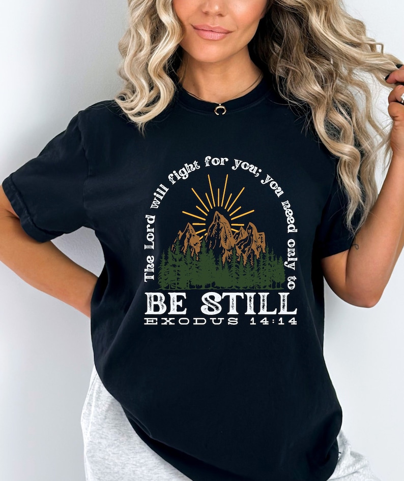 May include: Black t-shirt with a mountain scene and the text "The Lord will fight for you; you need only to BE STILL EXODUS 14:14"
