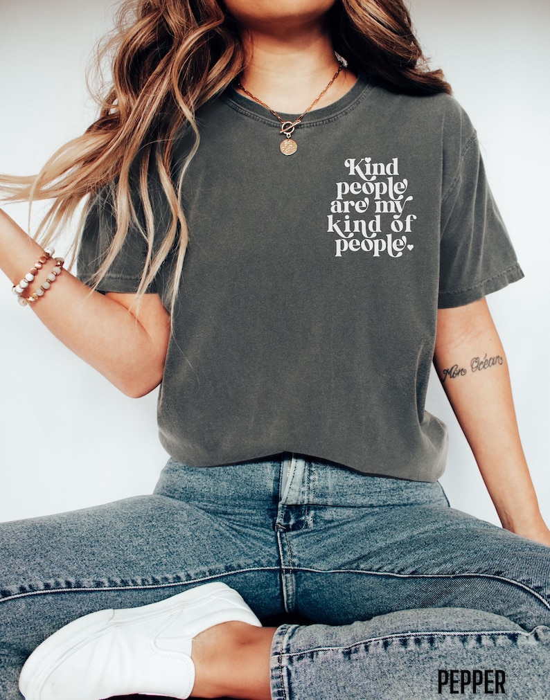 May include: A dark gray t-shirt with the text "Kind people are my kind of people." printed in white on the front.