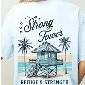 This shirt has a pocket design and the front and a back print design on the back.  It is based on Bible verses and says, God is my strong tower.  It features a lifeguard tower.  This is perfect for Christian teen girls or surfers.