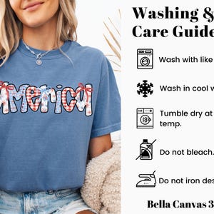 May include: A blue t-shirt with the word "America" printed on it in red, white, and blue. The shirt has a distressed look and is made by Bella Canvas. The image also includes washing and care instructions for the shirt.